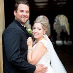 Bride and groom look at camera in front of the arches at Bethesda Fountain