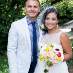 Groom with bride wearing birdcage veil and holding colorful bouquet Central Park