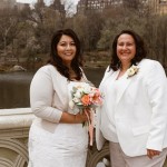 Two brides pose on Bow Bridge Central Park