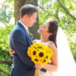 Wedding Couple with Bride holding bouquet of sunflowers