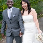 Bride and groom smiling and walking in Central Park