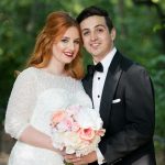 Bride and groom portrait with bride holding bouquet of blush flowers