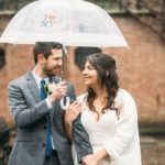 Bride and groom under umbrella at Conservatory Garden