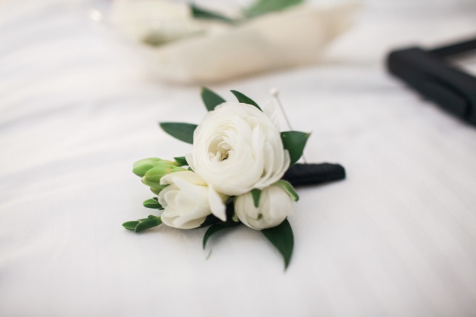 White ranunculus and freesia boutonniere