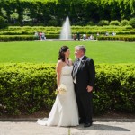 Newlyweds looking at each other in front of the Italian Garden and fountain