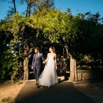 Bride and groom walking out of Cop Cot during golden hour