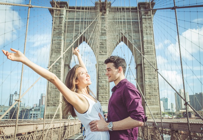 47114328 - happy couple hugging each other on the famous brooklyn bridge. concept about love,travel and people