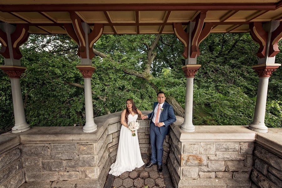 Newlyweds pose under terrace at Belvedere Castle