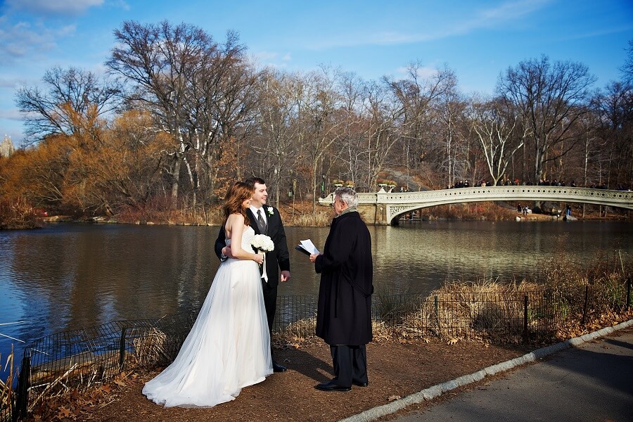 Couple has intimate wedding along Lake with Bow Bridge in background