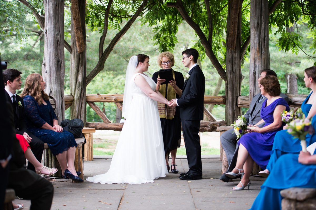 NYC Outdoor Wedding Venues & Locations: Couple exchanges wedding vows at Cop Cot Central Park