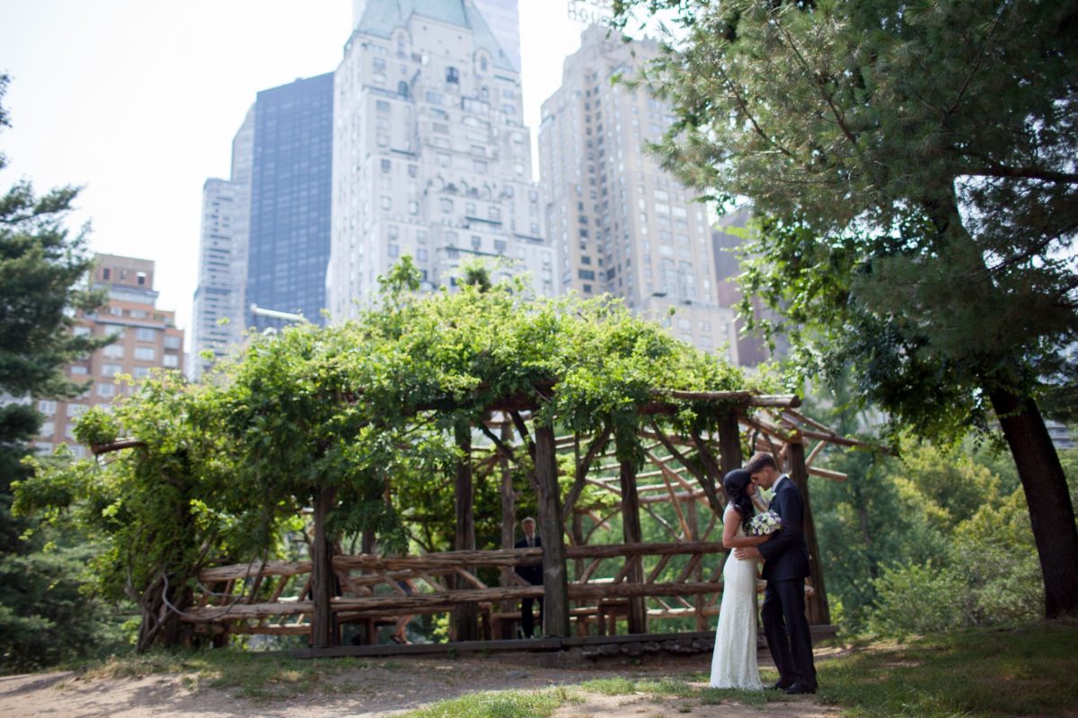 NYC Outdoor Wedding Venues & Locations: Newlyweds outside of Cop Cot with Essex House in background