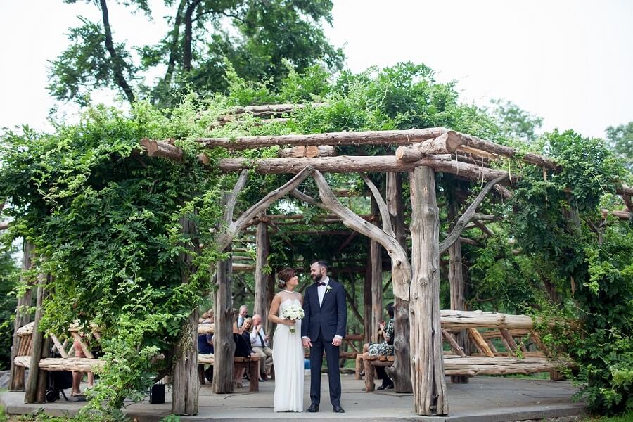 NYC Outdoor Wedding Venues & Locations: Bride and groom standing in front of Cop Cot gazebo