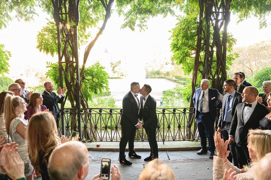 Gay wedding ceremony at Wisteria Pergola in the Conservatory Garden
