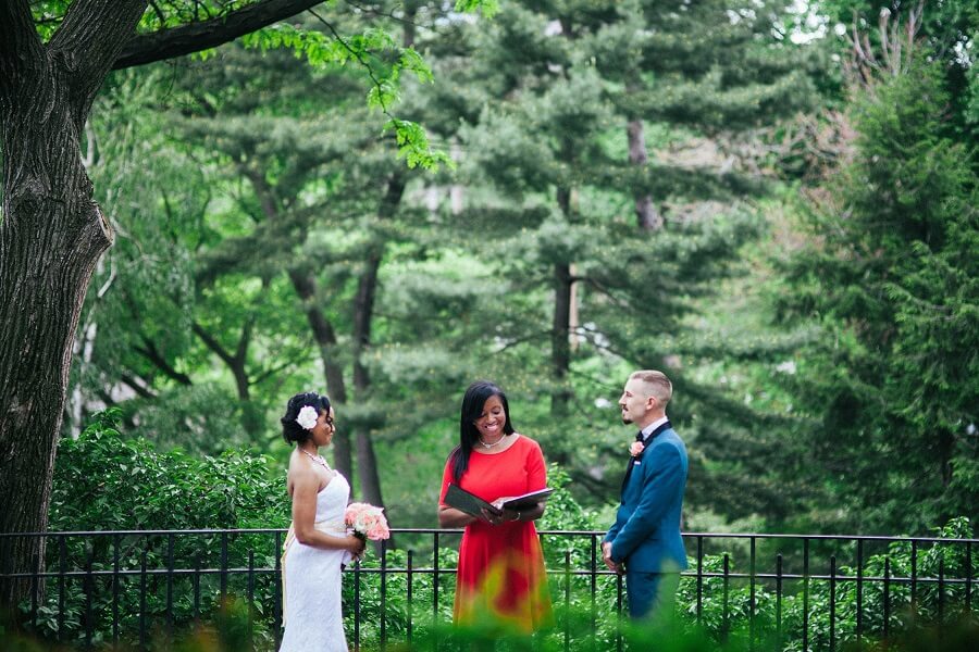 Bride and groom exchanging wedding vows in Shakespeare Garden