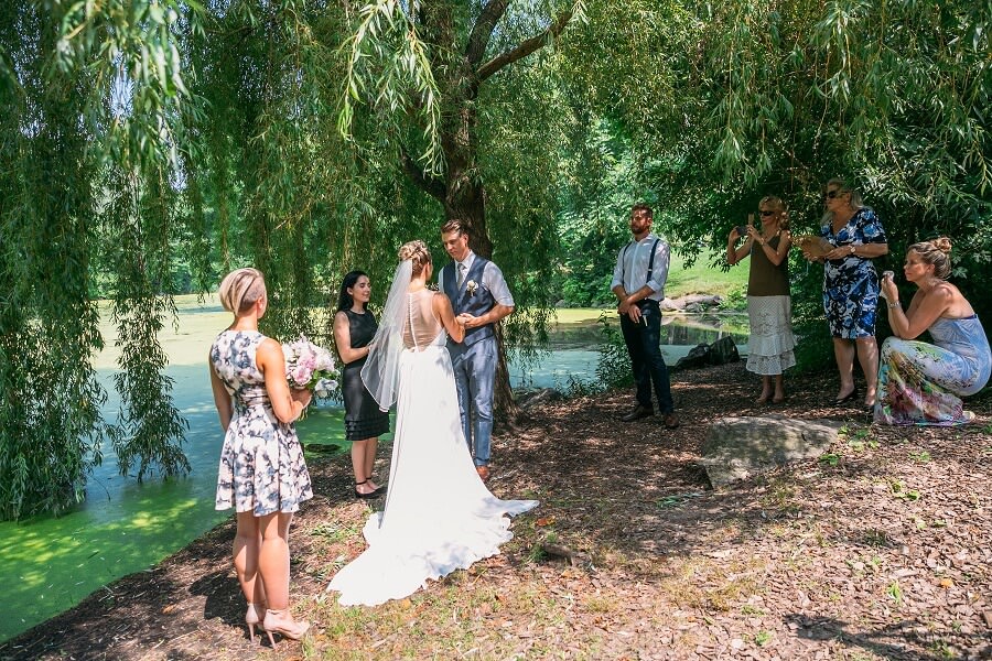 Intimate wedding ceremony under willow tree by Pool in Central Park