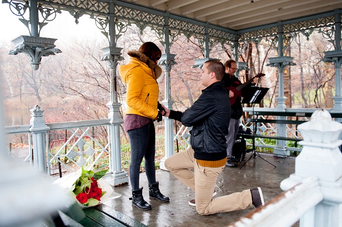 Man proposes to girlfriend in winter at the Ladies Pavilion with guitarist playing in background