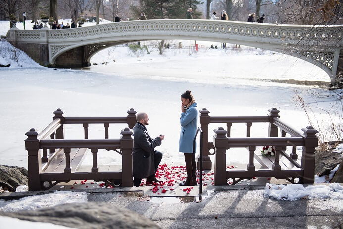 Winter proposal in Central Park on Bow Bridge landing