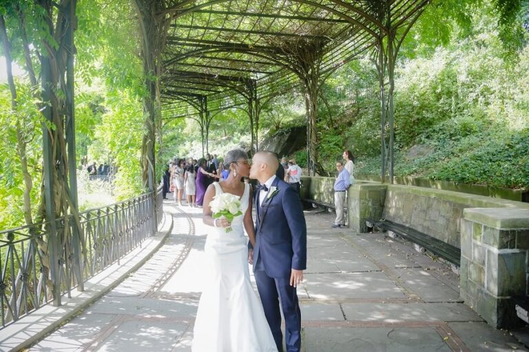 Bride and groom kiss after pronounced married at the Wisteria Pergola
