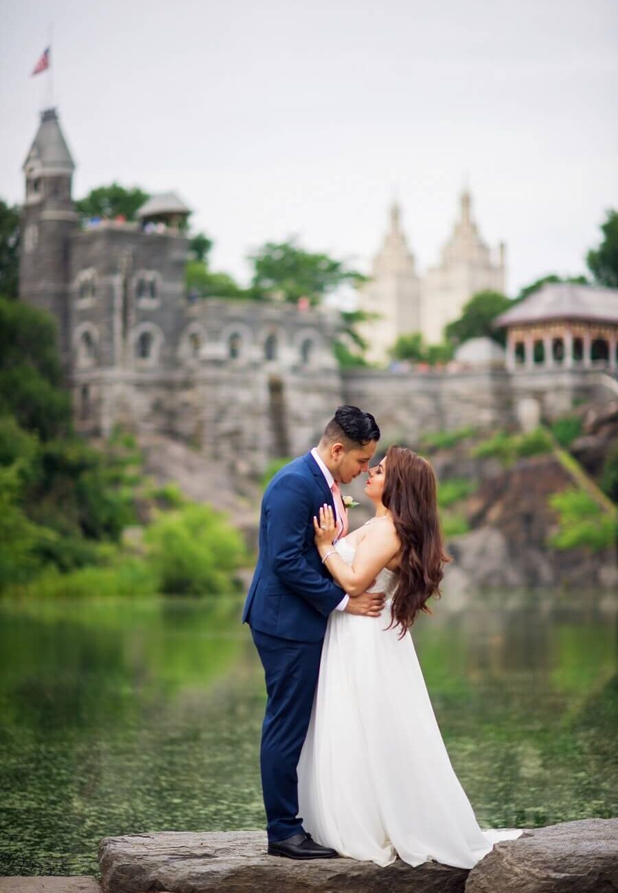 Bride and groom pose with Belvedere Castle in the background