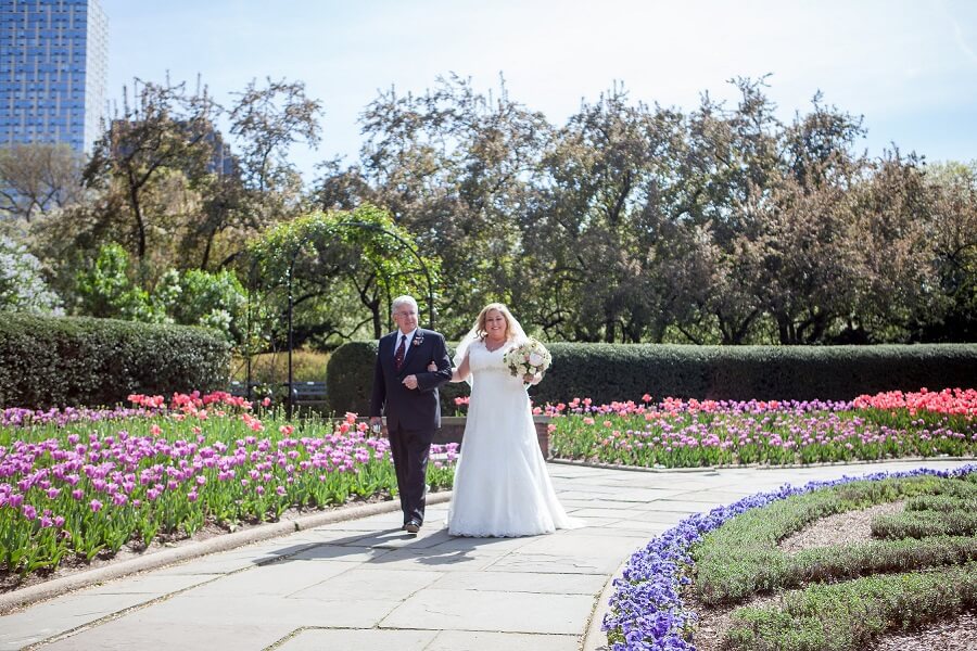 Father escorts bride down aisle in North Garden surrounded by tulips