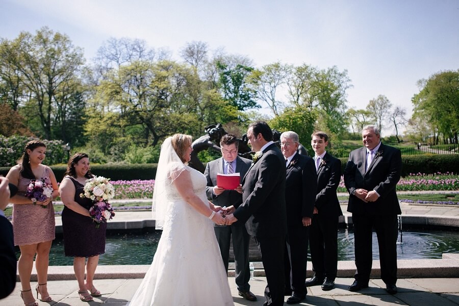 Bride and groom exchange vows in front of Untermyer fountain in Conservatory Garden