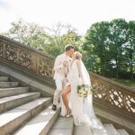 Bride and groom kiss on stairs at Bethesda Fountain