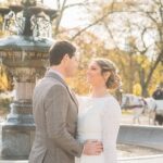 Bride looks at groom in front of Cherry Hill fountain in Fall
