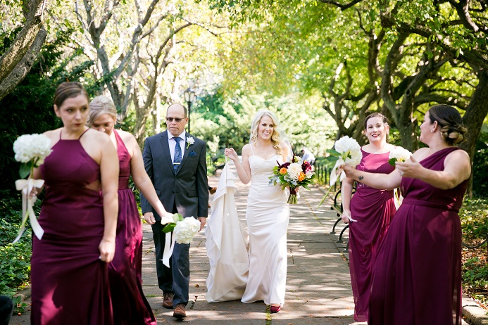 Bride walks through Conservatory Garden with Bridesmaids