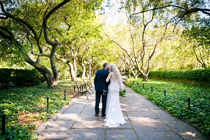 Bride and groom walk through the Conservatory Garden in NYC