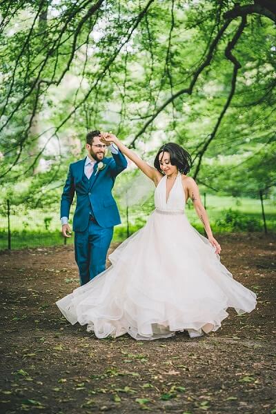 Groom twirls bride in Central Park