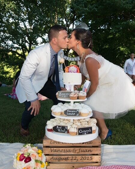 Newlyweds kiss over cupcake tower at Central Park picnic reception