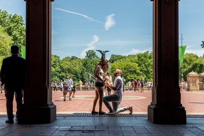 Man proposes under the arches of Bethesda Fountain in Central Park