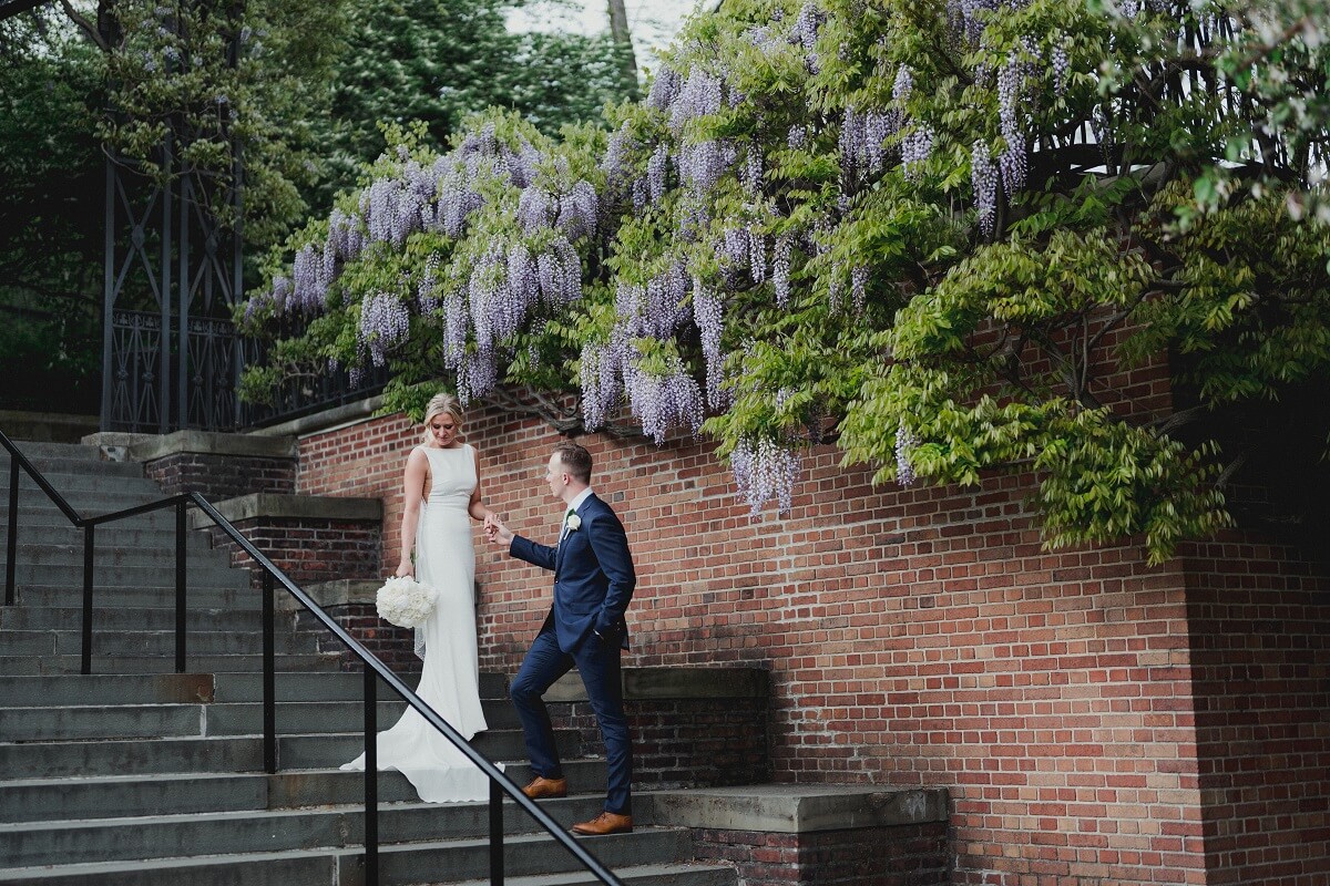 Bride and Groom pose by the Wisteria Pergola in Central Park